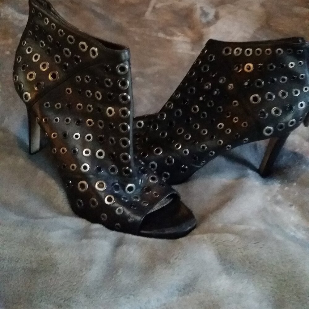 BCBGMAXAZRIA Lange Grommet Peep Toe Bootie in black leather.